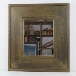 A brass framed mirror having foliate design upon, mirror 30 x 25cm, overall 51 x 56cm.