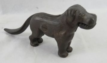 A cast iron nut cracker in the form of a dog.