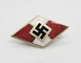 A red and white enamelled Swastika badge, makers mark Otto Hoffmann.