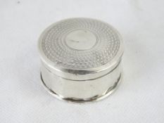 A hallmarked silver hinged pill pot.