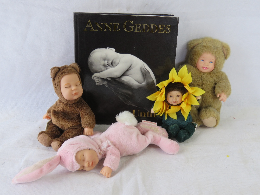 Anne Geddes; art book and four baby dolls including bear and sunflower,