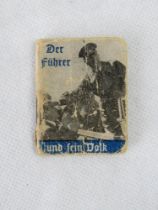 A WWII German propaganda miniature photograph book 'Der Fuhrer Und Sein Folk'.