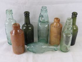 A collection of glass and stoneware bottles.