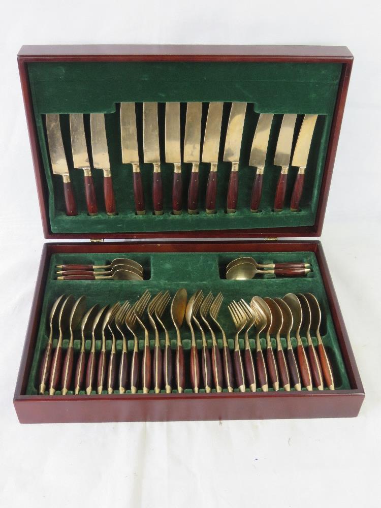 A brass and wood cutlery set.