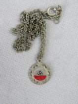 A red enamelled Swastika pendant on chain.
