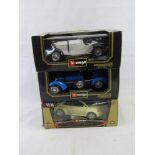 Three Burago 1:18 scale vehicles.