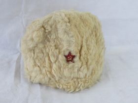 A WWII Soviet Russian winter hat with badge upon.