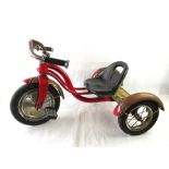 A Child's Schwinn tricycle, original pedals, some water damage to wooden panel to rear.