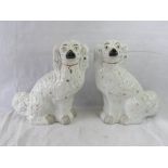 A pair of opposing Staffordshire Spaniels, 32cm high.