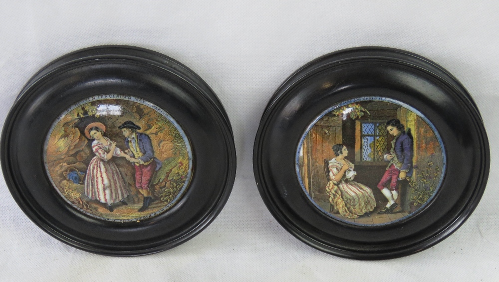 A pair of Pratts style pot lids mounted in ebonised frames.