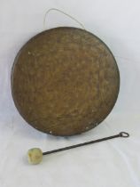 A large copper gong with beater, 14" dia (37cm).