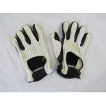 A pair of mens part leather driving gloves.