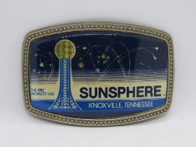 A 1982 Knoxville Tennessee World Fair Sunsphere belt buckle.
