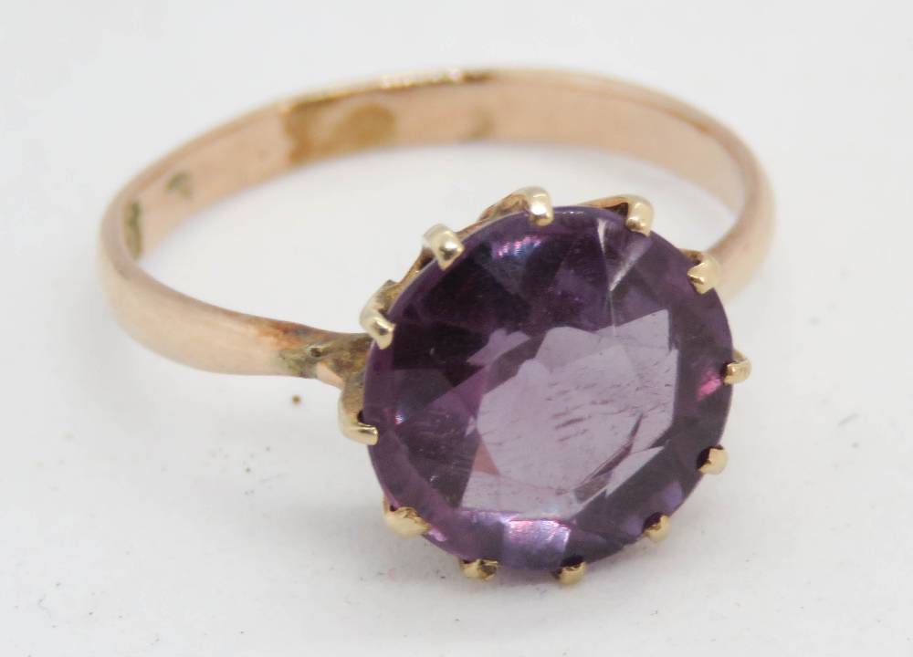 A stunning alexandrite solitaire ring, the round brilliant cut approx 9mm dia, band stamped 14,