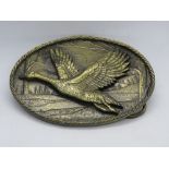 A Great American Buckle Co Chicago duck in flight belt buckle c1980s, serial number 470,