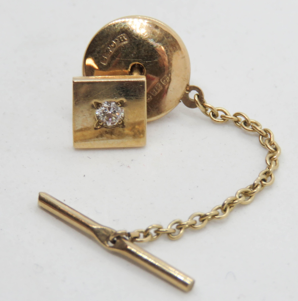 A 9ct gold and diamond tie stud, having gold covering to base metal clasp,