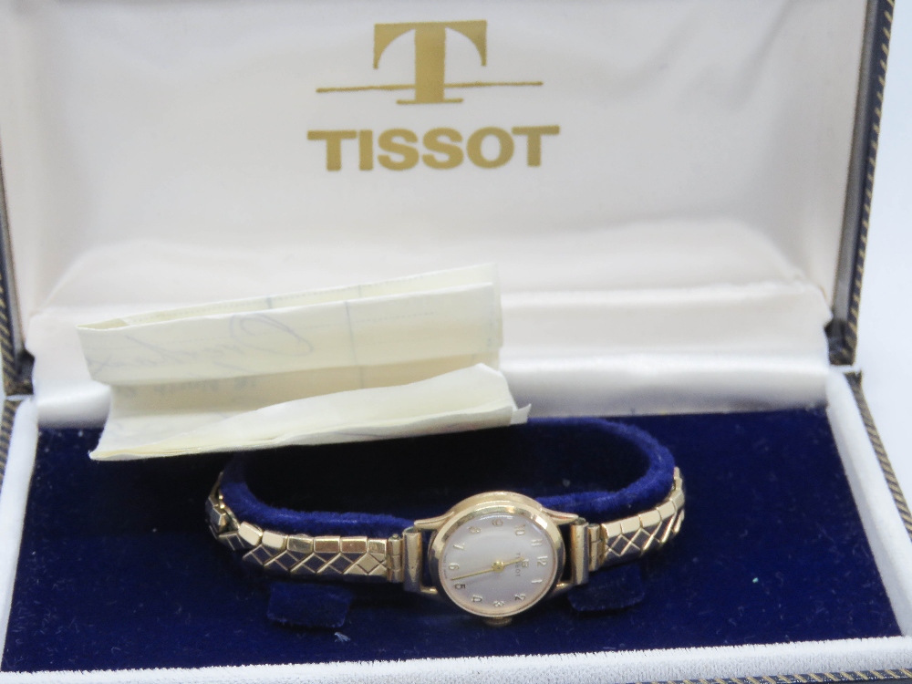 A 1960's 9ct gold Tissot ladies wristwatch on expanding Excalibur strap, within original box.