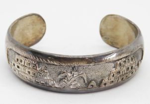 A heavy Sterling silver bangle with Arabic style decoration upon, 44.2g.