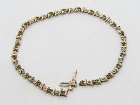 A 9ct gold diamond and emerald tennis bracelet, a/f, hallmarked 375, 6.3g.