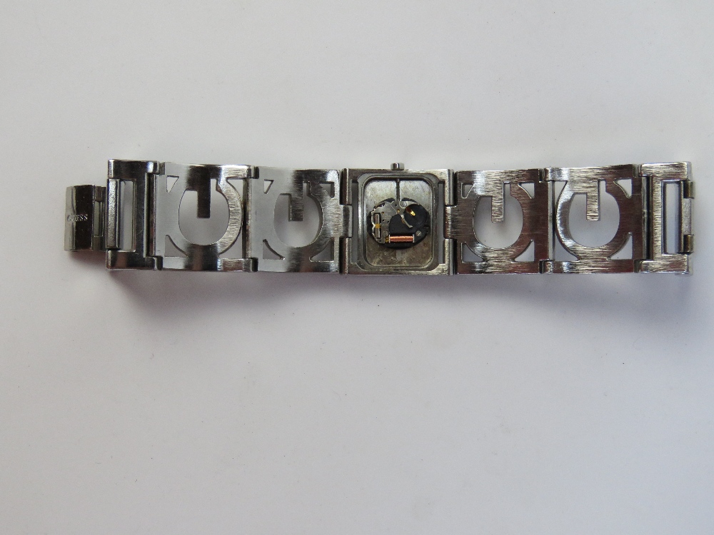 A ladies white stone encrusted wrist watch by Guess, case back deficient. - Image 3 of 3