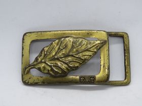 A vintage RJ Reynolds Tobacco USA belt buckle, marked to back with made in USA 1982.