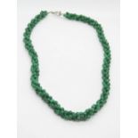 A three strand woven jade bead necklace with chrome clasp, 46cm.