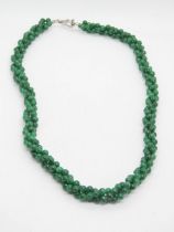 A three strand woven jade bead necklace with chrome clasp, 46cm.