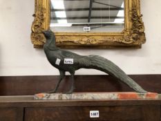 A SPELTER PEACOCK MOUNTED ON A MOTTLED RED MARBLE RECTANGULAR PLINTH