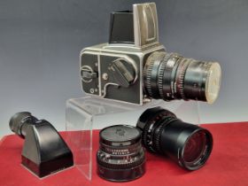 A CASED HASSELBLAD 500C/M CAMERA WITH ZEISS SONNAR 1:4, DISTAGON 1:4 AND PLANAR 1:2.8 LENSES,