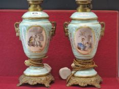A PAIR OF FRENCH PALE BLUE GROUND PORCELAIN OIL LAMPS AS TABLE LAMPS PAINTED WITH OVALS OF