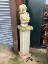 A HALF LENGTH BUST OF A GIRL READING ON TALL COLUMN SUPPORT.