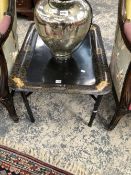 A GILT BLACK TWO HANDLED TOLE TRAY TOPPED COFFEE TABLE