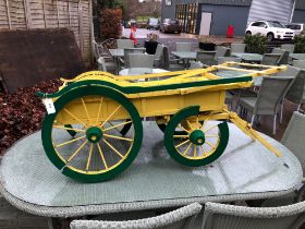 A SMALL SCALE HAY CART , PROBABLY FOR A DOG.