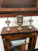A PAIR OF EASTERN PEWTER ALLOY PRICKET CANDLESTICKS TOGETHER WITH A TWO HANDLED URN