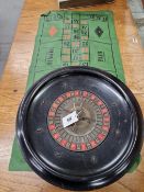 A ROULETTE WHEEL, STAMPED WHEEL MARK AND MA MONOGRAM. Dia 43cms. A PRINTED CLOTH BY K & C LONDON,