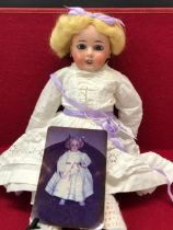 A LIMOGES BISQUE HEADED DOLL WITH FIXED EYES AND OPEN MOUTH. H 48cms.