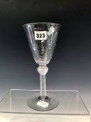 AN EARLY 19th C. AIR TWIST WINE GLASS, THE BASE OF THE CONICAL BOWL WITH HAMMERED DECORATION ABOVE A