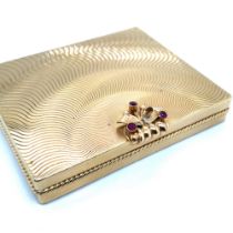 A VINTAGE SOLID GOLD LADIES COMPACT WITH A RUBY CLASP. THE CASE AND POWDER HOLDER STAMPED 750,