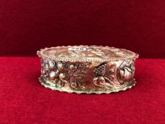A GERMAN 800 SILVER OVAL BOX, THE HINGED LID EMBOSSED WITH AN APPLE HARVESTING SCENE, THE SIDES WITH