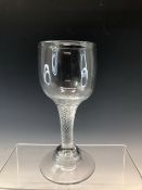 AN AIR TWIST WINE GOBLET ON A DOMED CIRCULAR FOOT. H 18cms.