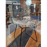 ATTRIBUTED TO BERTOIA WIRE WORK CHAIR WITH A WHITE SEAT AND BACK AND ON BLACK LEGS