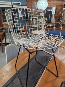 ATTRIBUTED TO BERTOIA WIRE WORK CHAIR WITH A WHITE SEAT AND BACK AND ON BLACK LEGS