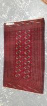 AN ANTIQUE TEKKE BOKHARA RUG. 183 x 114cms