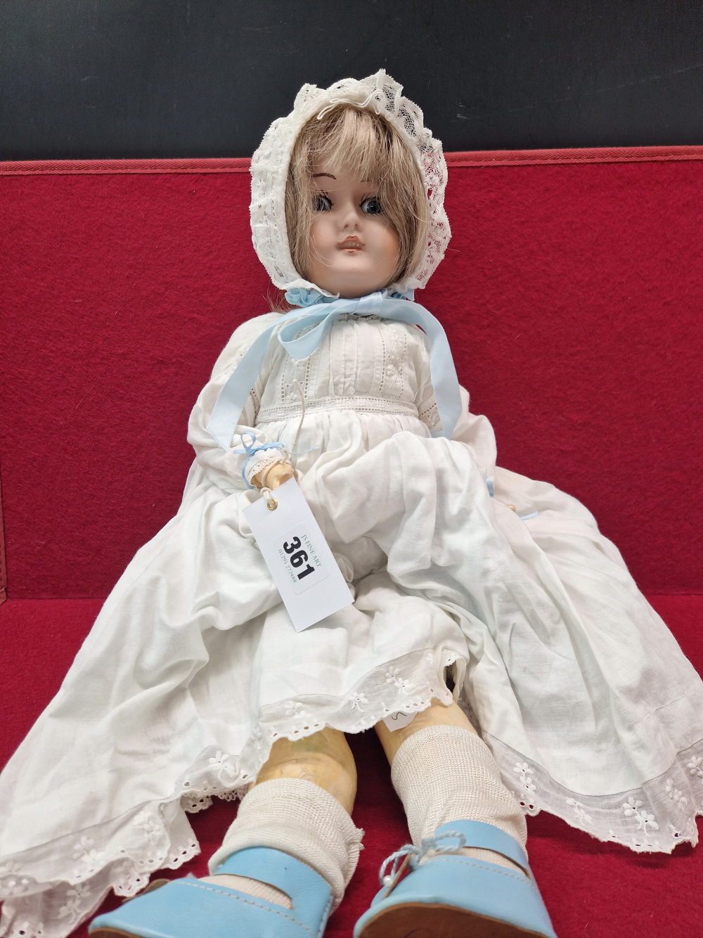 AN ENGLISH BISQUE HEADED DOLL WITH MOVING EYES AND CLOSED MOUTH. H 51cms.