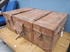 A LARGE ANTIQUE LEATHER TRUNK WITH TWO STRAPS AND HANDLES. W 96 x D 60 x H 36cms.