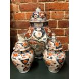 A PAIR OF 18th C. JAPANESE IMARI JARS AND COVERS. H 26cms. TOGETHER WITH ANOTHER LARGER. H 43cms.