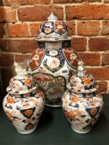 A PAIR OF 18th C. JAPANESE IMARI JARS AND COVERS. H 26cms. TOGETHER WITH ANOTHER LARGER. H 43cms.