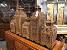 TWO TALL AND THREE OTHER PIERCED IRON CANDLESTICK LANTERNS