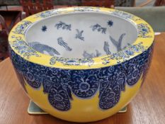 A PAIR OF CHINESE FISH BOWLS WITH THE INTERIORS DECORATED IN BLUE WITH FISH, THE YELLOW GROUND