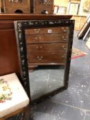 AN ANTIQUE RECTANGULAR MIRROR IN A CHINESE BLACK LACQUER FRAME INLAID WITH MOTHER OF PEARL FLOWERS